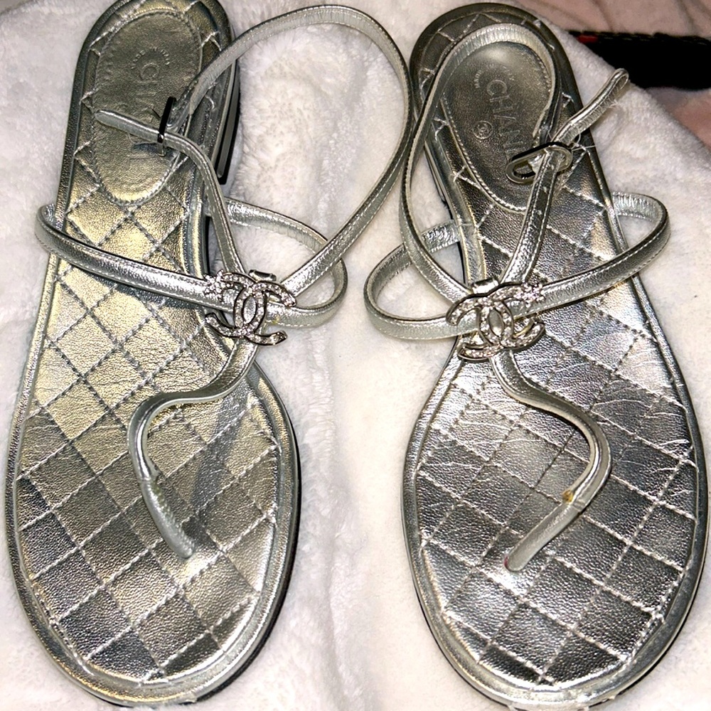Silver Chanel sandals with crystal CC embellished on the top of the sandal.